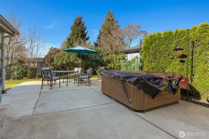 Private back patio with western exposure, turf lawn and overlooks the community pond-