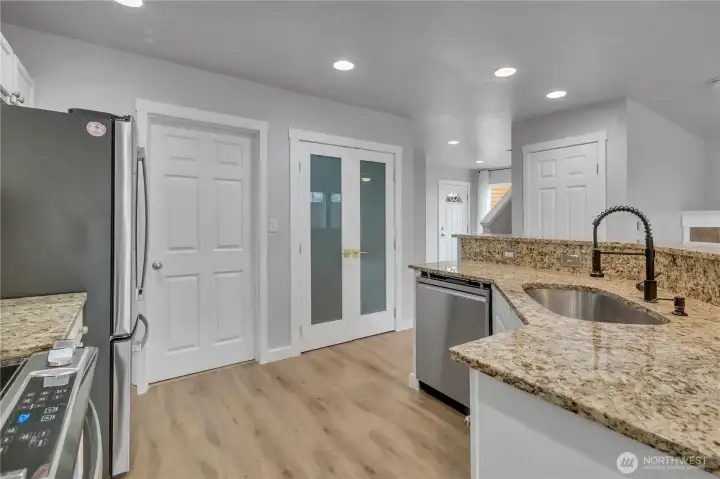 View of front door from kitchen area.