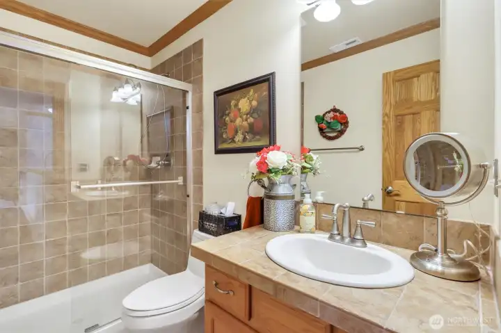 There is a bathroom with a walk in shower right next to the bedroom