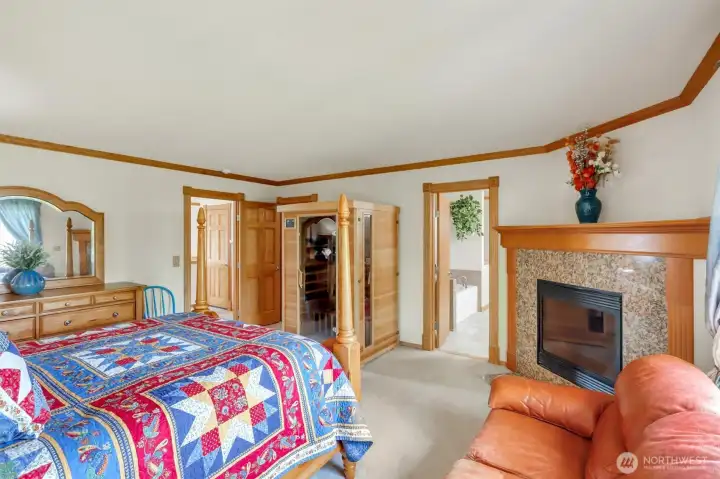 The primary bedroom features a beautiful fireplace