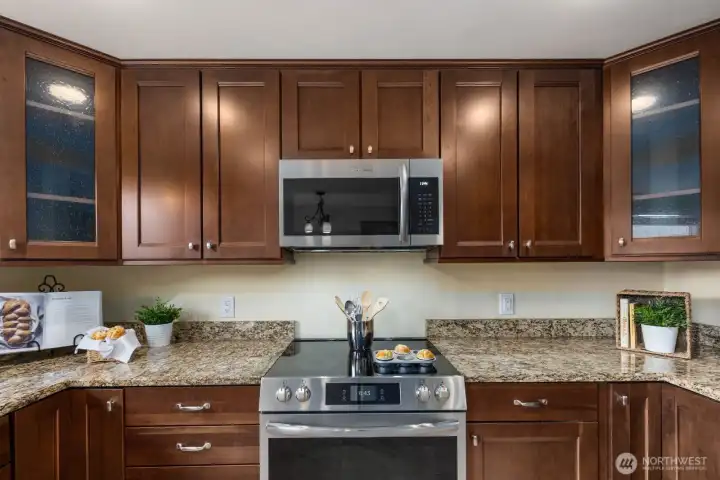 Kitchen with wood cabinetry, stainless steel appliances, and ample counter space. Designed for efficient use with good storage and workspace.