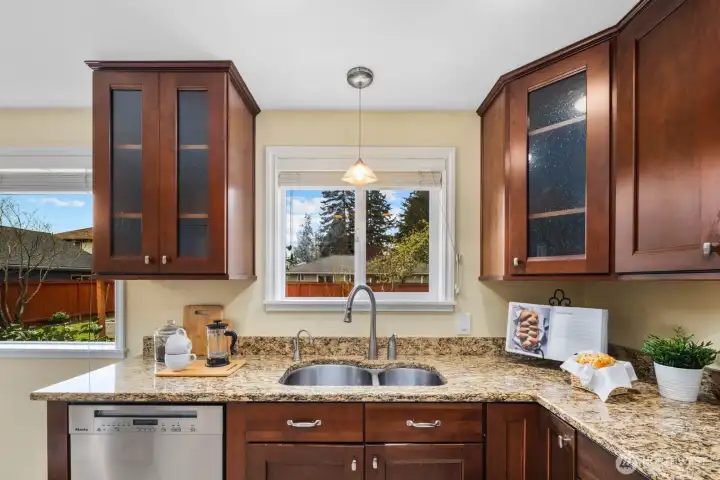 Kitchen with wood cabinetry, stainless steel appliances, and ample counter space. Designed for efficient use with good storage and workspace.