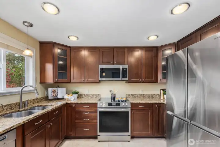 Kitchen with wood cabinetry, stainless steel appliances, and ample counter space. Designed for efficient use with good storage and workspace.