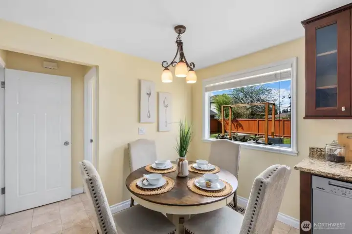 Dining area adjacent to kitchen with window views and space for everyday meals. Functional layout connects easily to surrounding living areas.