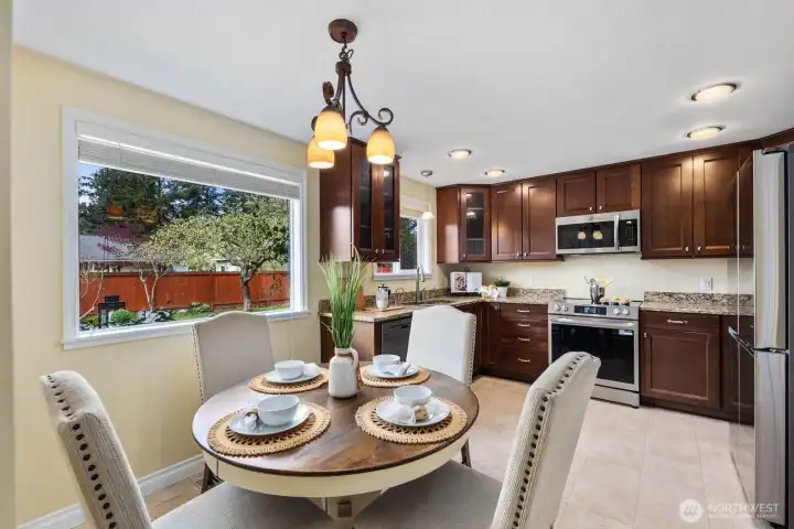 Dining area adjacent to kitchen with window views and space for everyday meals. Functional layout connects easily to surrounding living areas.