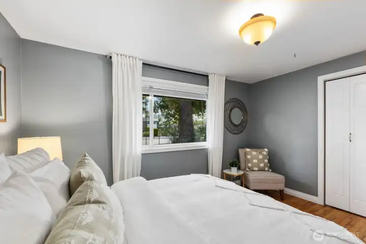 Bedroom with neutral finishes, window for natural light, and closet storage. Provides a comfortable and private sleeping area.