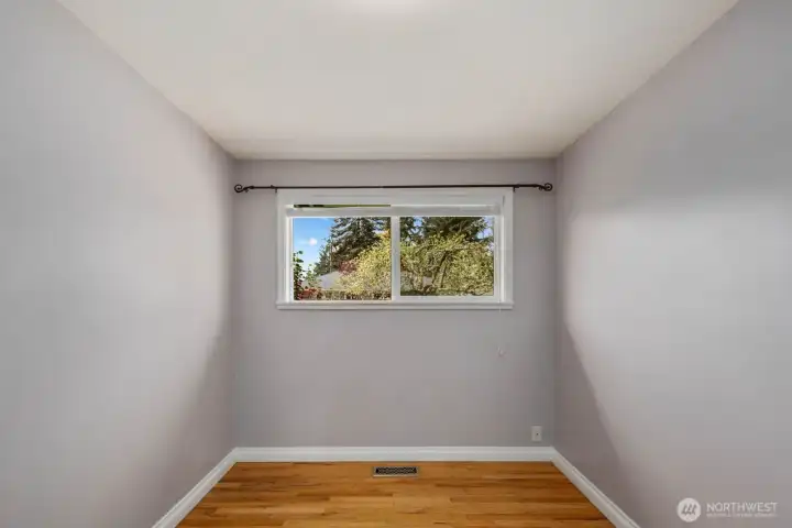 Additional room with hardwood floors, painted walls, and window for natural light. The flexible layout works well as a bedroom, home office, hobby room, or other everyday living space.