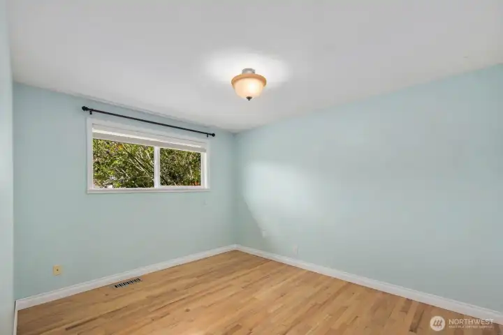 Additional room with hardwood floors, painted walls, and window for natural light. The flexible layout works well as a bedroom, home office, hobby room, or other everyday living space.