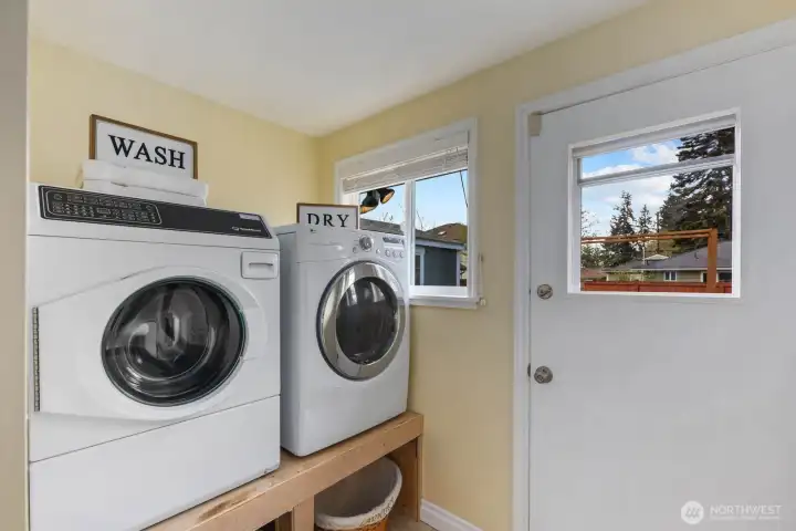Laundry room with washer, dryer, utility sink, and window. Dedicated space adds convenience for daily household use.