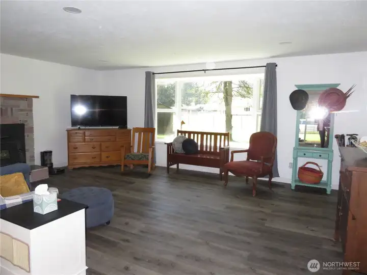 Living room with a bat window and wood stove