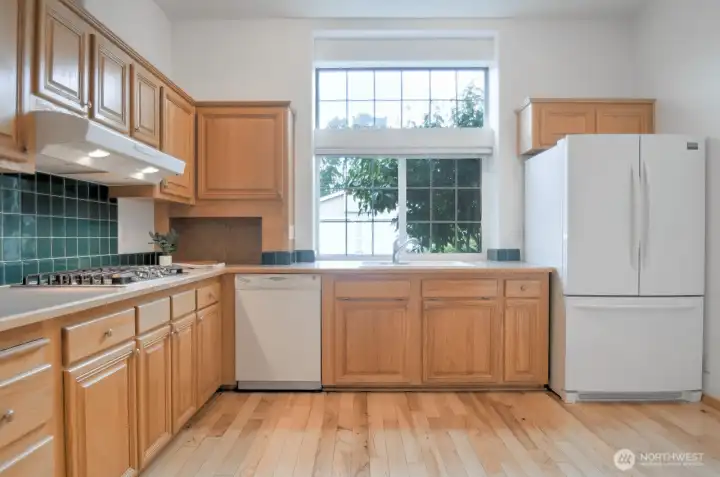 Natural light streams into the kitchen through the huge picture window