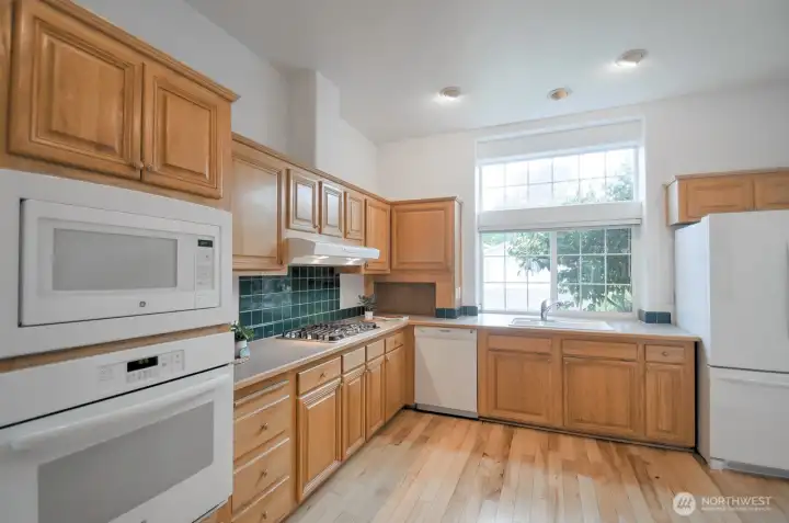 This kitchen is a cook's delight with bottom and top cabinets providing a place for all of your culinary tools
