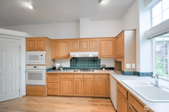 Another view of the kitchen with a walk-in pantry to the left