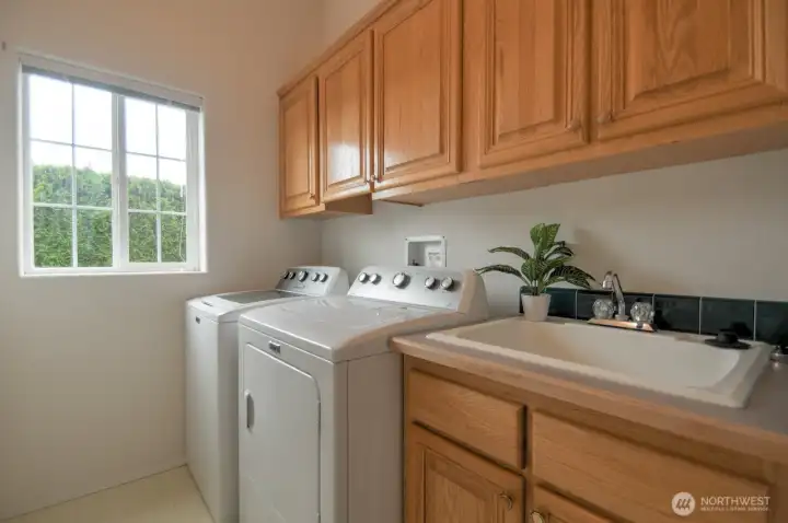 Laundry room (washer and dryer included) with more cabinet storage