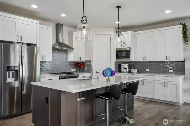 Spacious kitchen featuring quartz countertops and ample cabinetry for storage and functionality