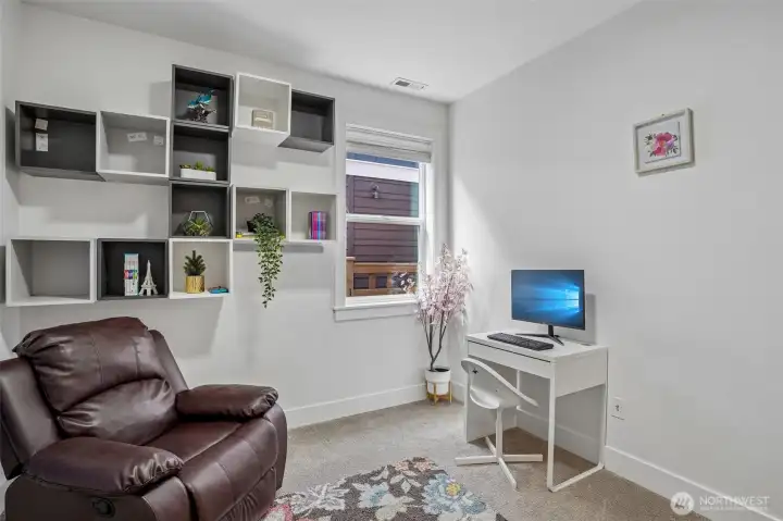 Main-floor flex space ideal for a home office, playroom, guest area, or additional living space