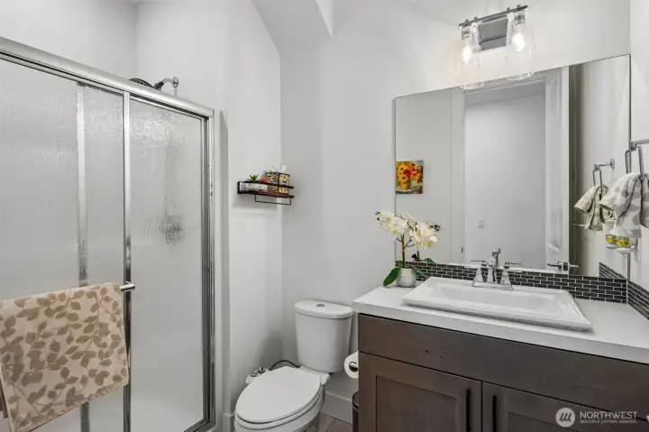 Convenient main-floor bathroom with shower adds flexibility for guests and multi-generational living