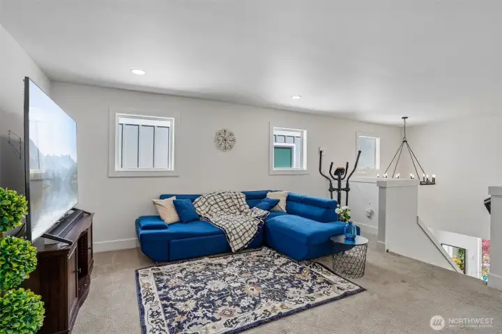 Spacious upstairs loft offers flexible living space perfect for a media room, home gym, play area, or secondary lounge