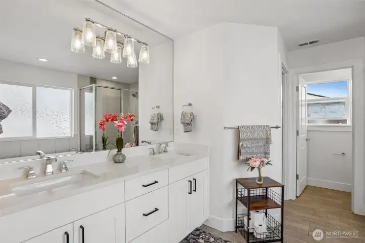 Primary bathroom features a clean, modern design with ample space, walk-in closet and everyday functionality
