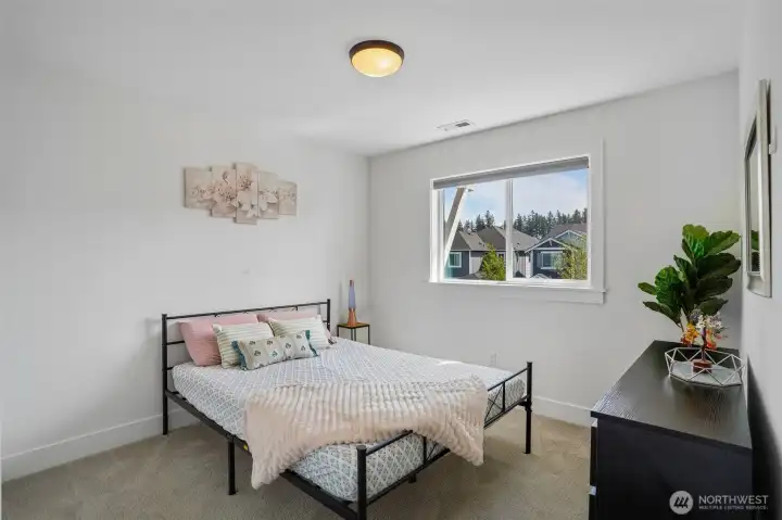 Additional bedrooms offer comfortable layouts with large windows that bring in plenty of natural light