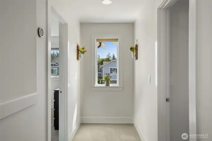 Beautiful passageway windows fill the home with abundant natural light, creating a bright and airy atmosphere throughout the upstairs living spaces