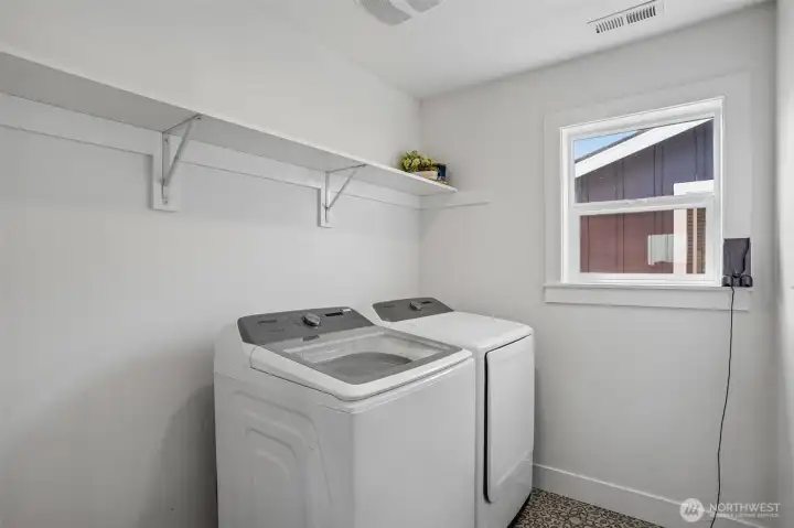 Second-floor laundry room offers added convenience and functional storage space