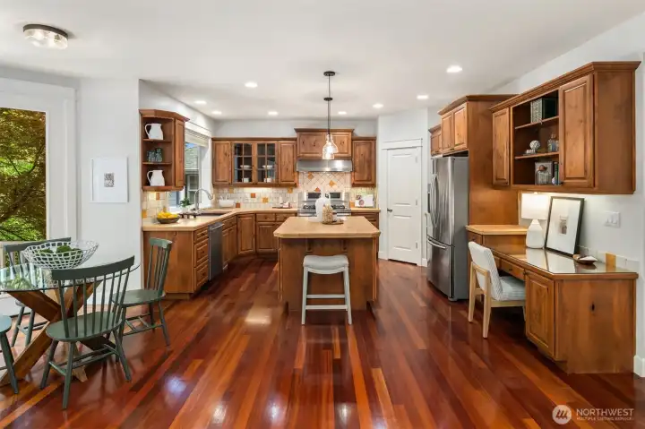 Kitchen features gorgeous cherry cabinets and flooring