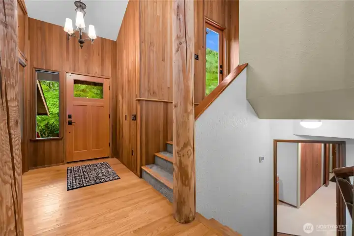 Main Entry Door with stairs to Primary Bedroom on the right, stairs down to Bedrooms 2 & 3 in the forefront of this photo Main Entry Door with stairs to Primary Bedroom on the right, stairs down to Bedrooms 2 & 3 in the forefront of this photo