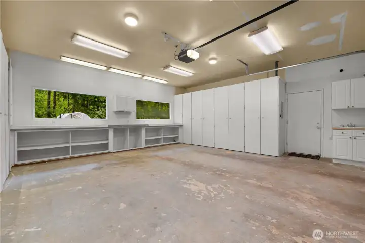Plenty of storage, a work bench and utility sink in the double-car garage Plenty of storage, a work bench and utility sink in the double-car garage