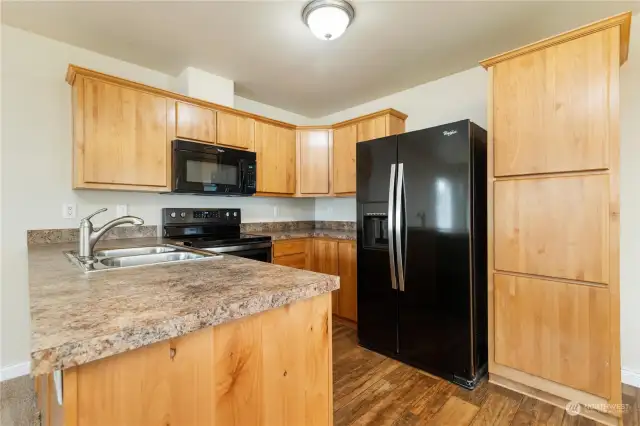 Roomy kitchen with black appliances