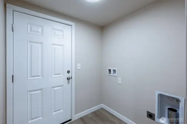 Laundry room with door to the back deck