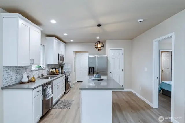Kitchen with quartz counters, island and all appliances