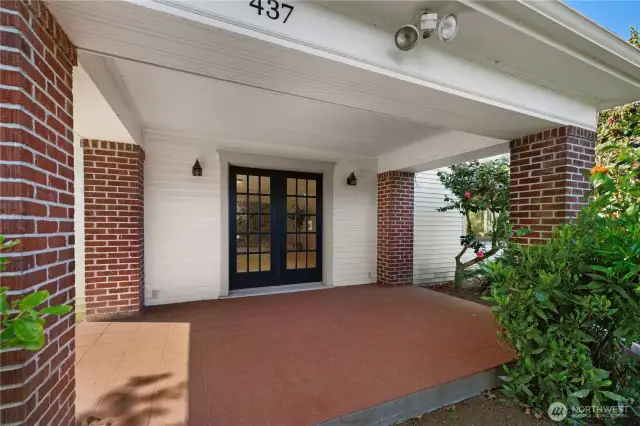 Living room french doors lead elegantly to beautiful patio