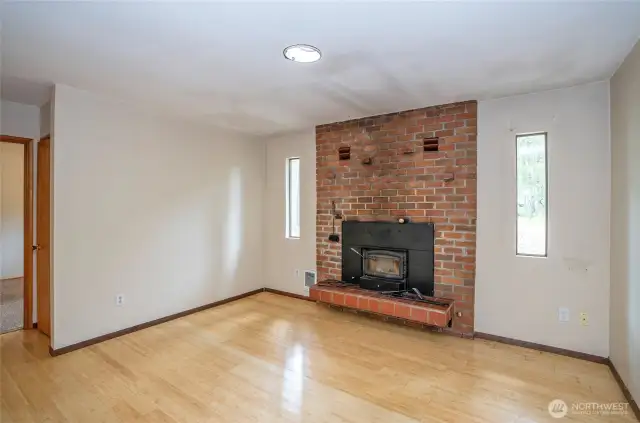 Family room with wood burning fireplace.