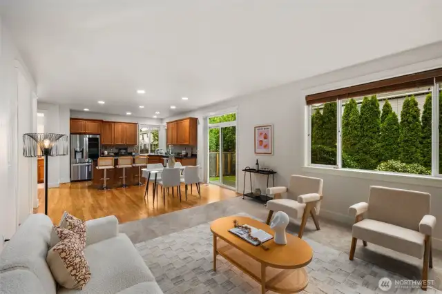 Great room perspective showing the large kitchen and dining space. Soooo much natural light in these spaces.