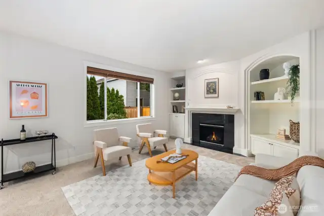 Custom built-ins in the informal great room. Cozy fireplace completes this space.