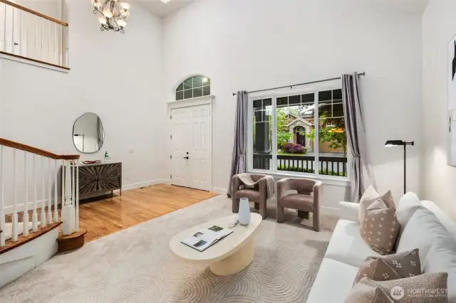 Soaring 22' ceilings create a wow factor entry and formal living space. New carpeting and freshly painted interior walls, trim and doors make this home move in ready.  This room is drenched in sunshine!