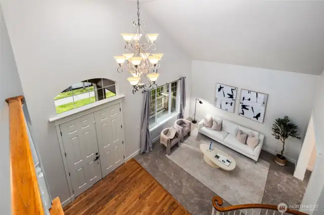 Soaring 22' ceilings create a wow factor entry and formal living space. New carpeting and freshly painted interior walls, trim and doors make this home move in ready.  Plenty of space allows for larger furnishing and art displays.  This room is always drenched in sunshine!
