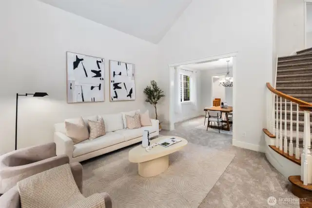 Formal and naturally-lit living space. New carpeting and freshly painted interior walls, trim and doors make this home move in ready.  Formal dining room to the right with an attached butler's pantry area.  Notice the vaulted ceilings?  Amazing space!