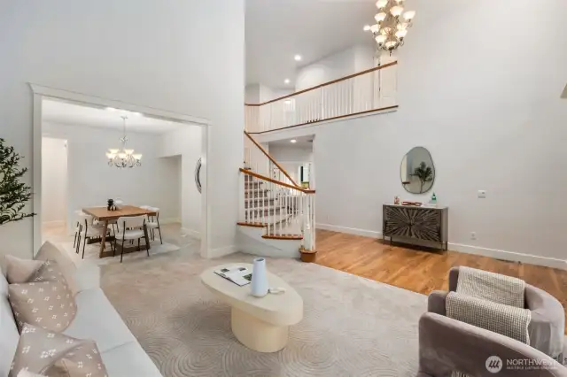 Formal and naturally-lit living space. New carpeting and freshly painted interior walls, trim and doors make this home move in ready.  Formal dining room to the right with an attached butler's pantry area.  Notice the vaulted ceilings?  Amazing space!