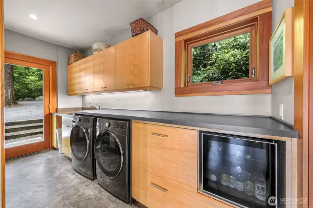 Laundry room + butler’s kitchen adjacent to kitchen facilities entertaining, with versatility. Beverage center, sink + counter space adds convenient and discreet workspace or a designated wet bar.