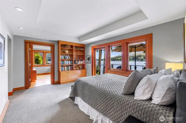 Primary bedroom with luxurious en-suite bathroom flows from the main-level living space. Special touches: built-in fir cabinetry and trim, and coved ceiling.