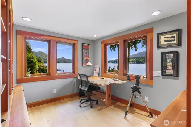 Flexible space adjoining the primary bedroom can be configured as a home office, reading or craft area, or even a nursery. Sunny Lake Samish and lush greenery are visible from each window.