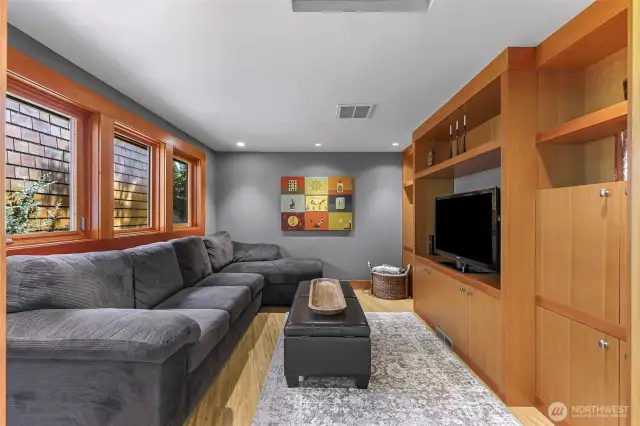Main-level den with pocket doors can serve as a quiet space or the perfect spot to watch your favorite sports.