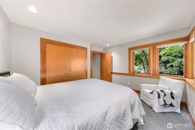 Upstairs bedroom with lush garden views.
