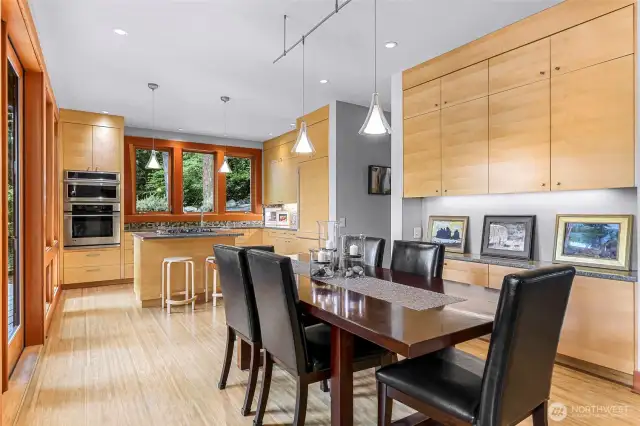 Indoor dining area is surrounded by wood and stone-clad buffet area.