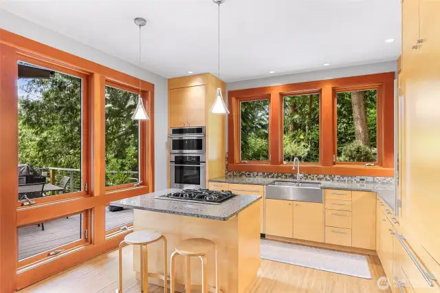 Custom cook’s open kitchen with solid maple kitchen cabinets, Pental stone slab countertops and Ann Saks tile backsplash. Gourmet appliances: Sub-Zero Refer, Miele Dishwasher, Built-in GE Oven and Microwave.