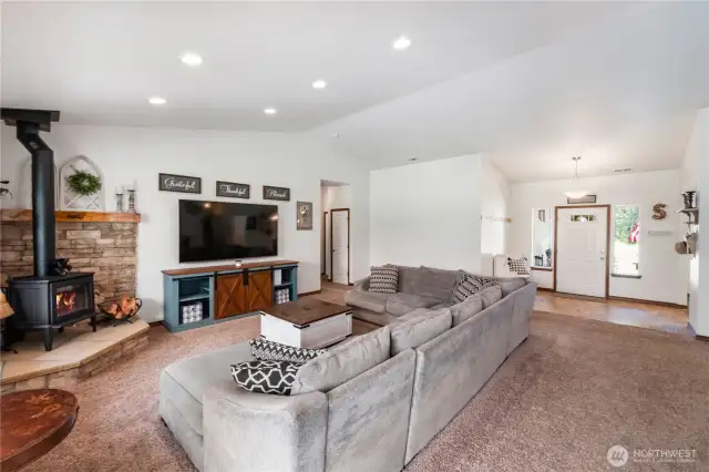 Great room features wood fireplace with sandstone hearth, stone surround and wood mantle for ambiance and those chilly winter nights.