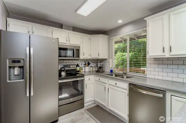 Updated stainless steel appliances (2017) elevate this Kent home’s sleek kitchen design.