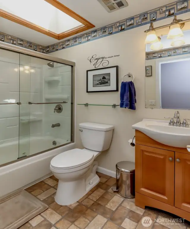 Bright guest bathroom with a skylight, adding natural light